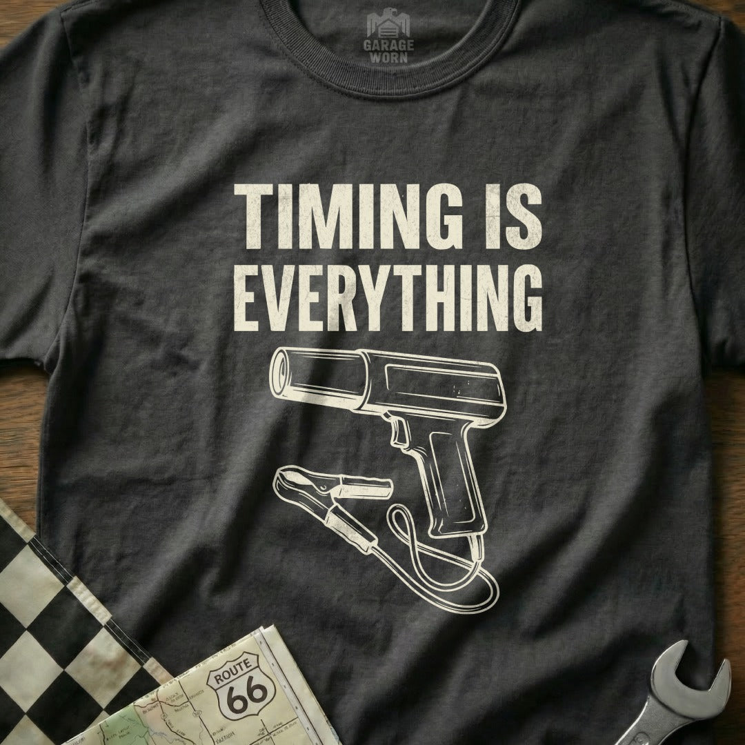Dark t-shirt with white text "TIMING IS EVERYTHING" and a graphic of a timing light.