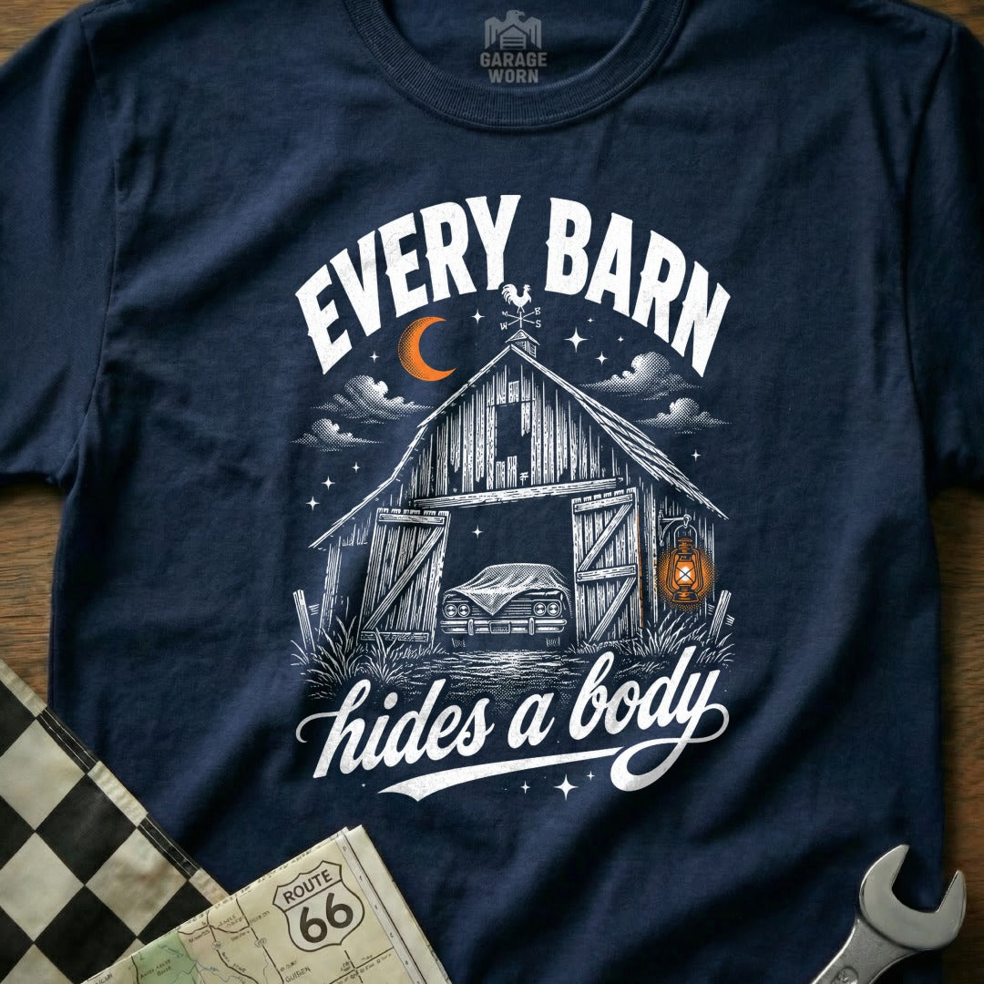 "Every Barn Hides a Body" graphic on a navy t-shirt with a barn and car illustration.
