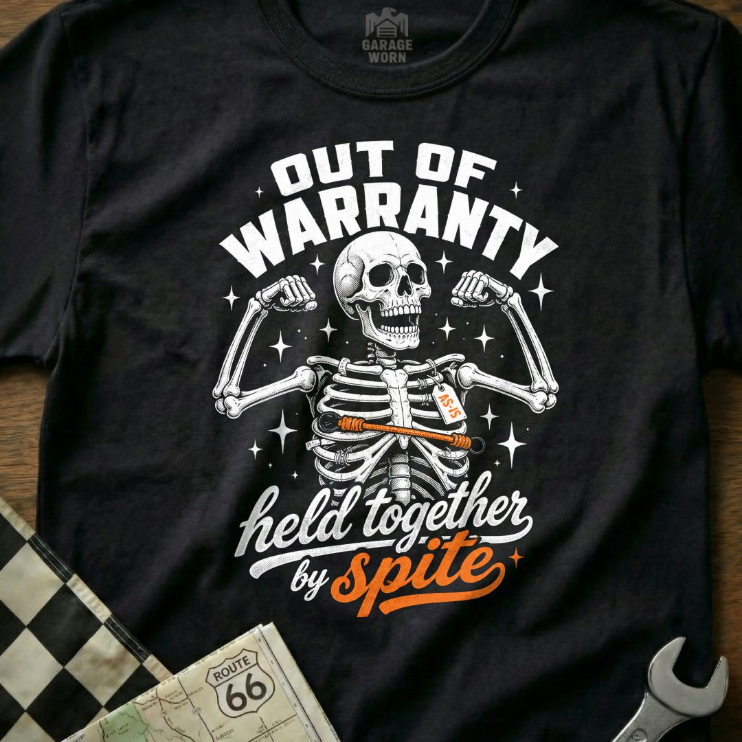 Black t-shirt with skeleton graphic and "Out of Warranty, held together by Spite" text.