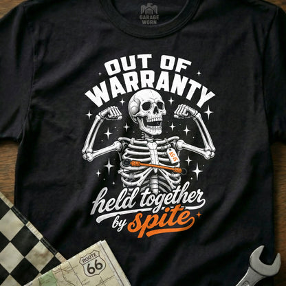 Black t-shirt with skeleton graphic and "Out of Warranty, held together by Spite" text.