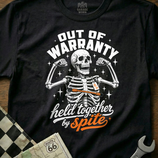 Black t-shirt with skeleton graphic and "Out of Warranty, held together by Spite" text.