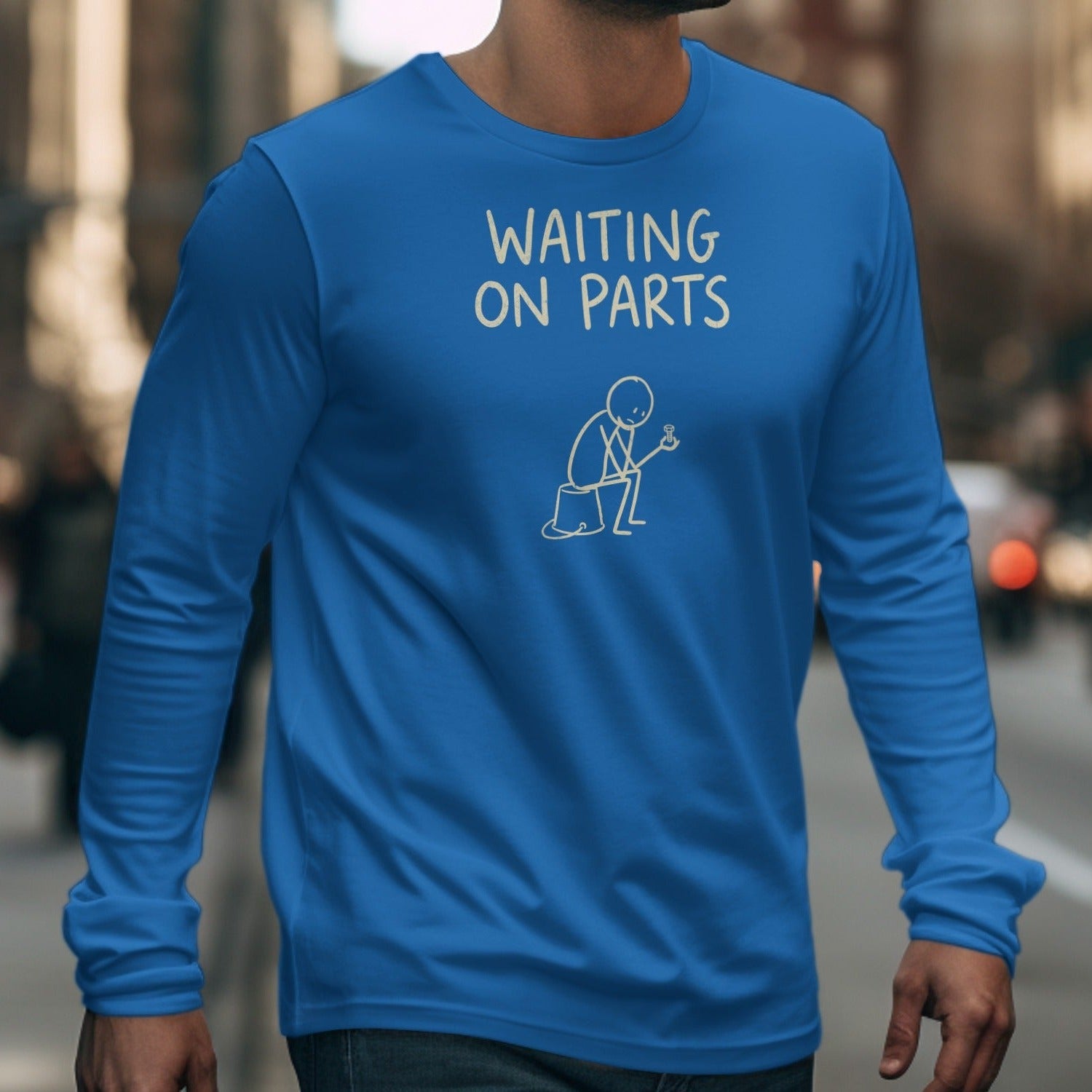 Blue long sleeve t-shirt with "Waiting on Parts" and stick figure holding a bolt.