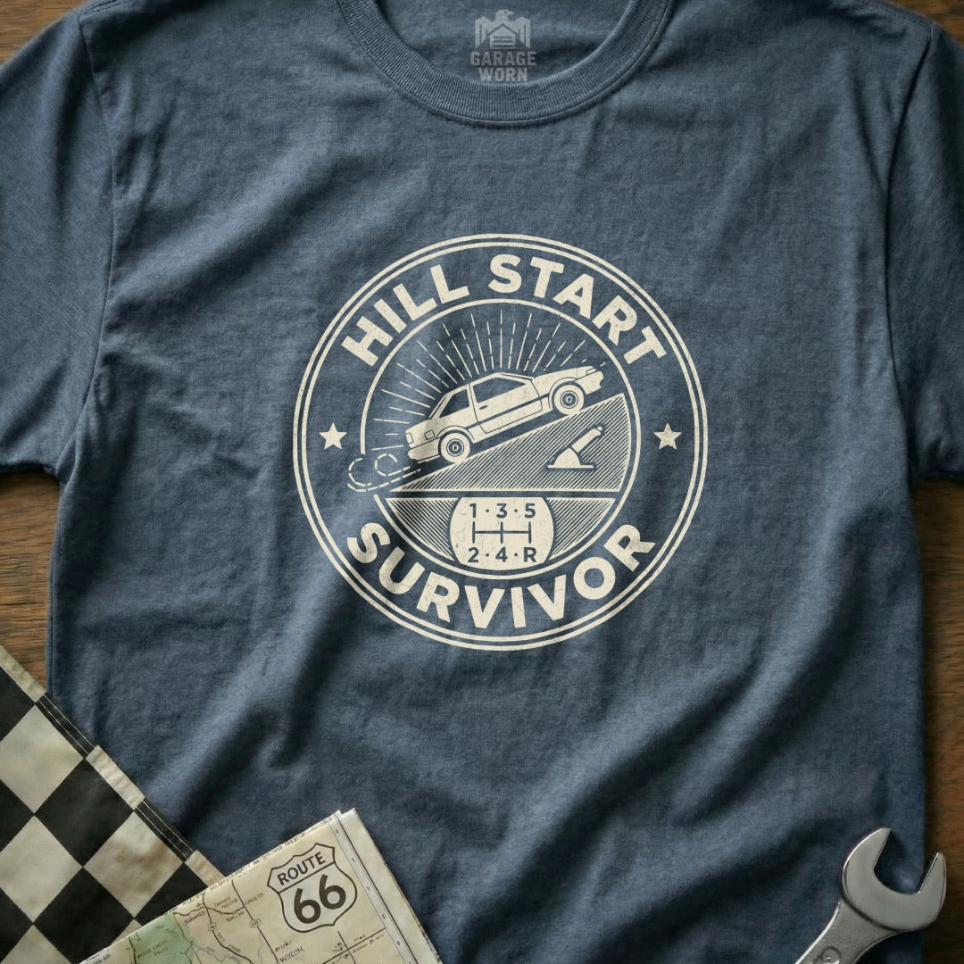 T-shirt with "Hill Start Survivor" text and car on an incline graphic.