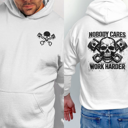 White hoodie with distressed skull and pistons graphic, text reads "Nobody Cares Work Harder".