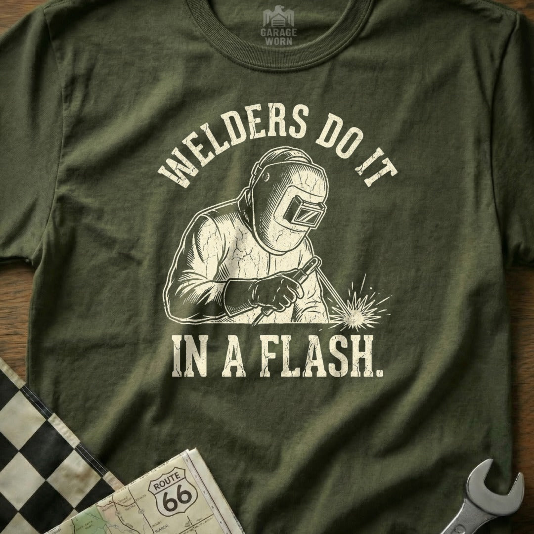 Olive t-shirt with graphic of a welder in action and text "WELDERS DO IT IN A FLASH."