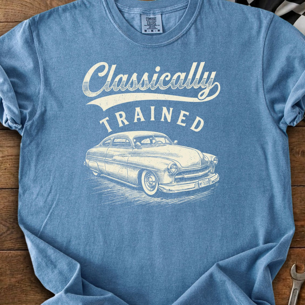 Blue t-shirt with "Classically TRAINED" text and vintage car graphic.