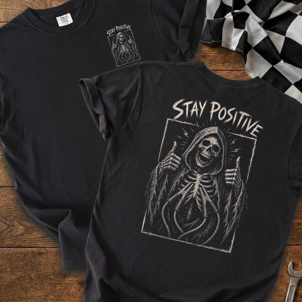 Black t-shirt with grim reaper graphic and "STAY POSITIVE" text.