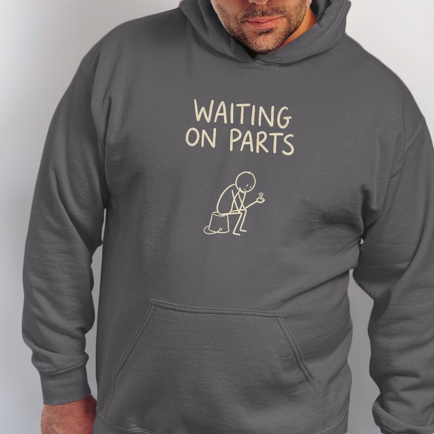 Dark gray hoodie with "WAITING ON PARTS" text and stick figure graphic.