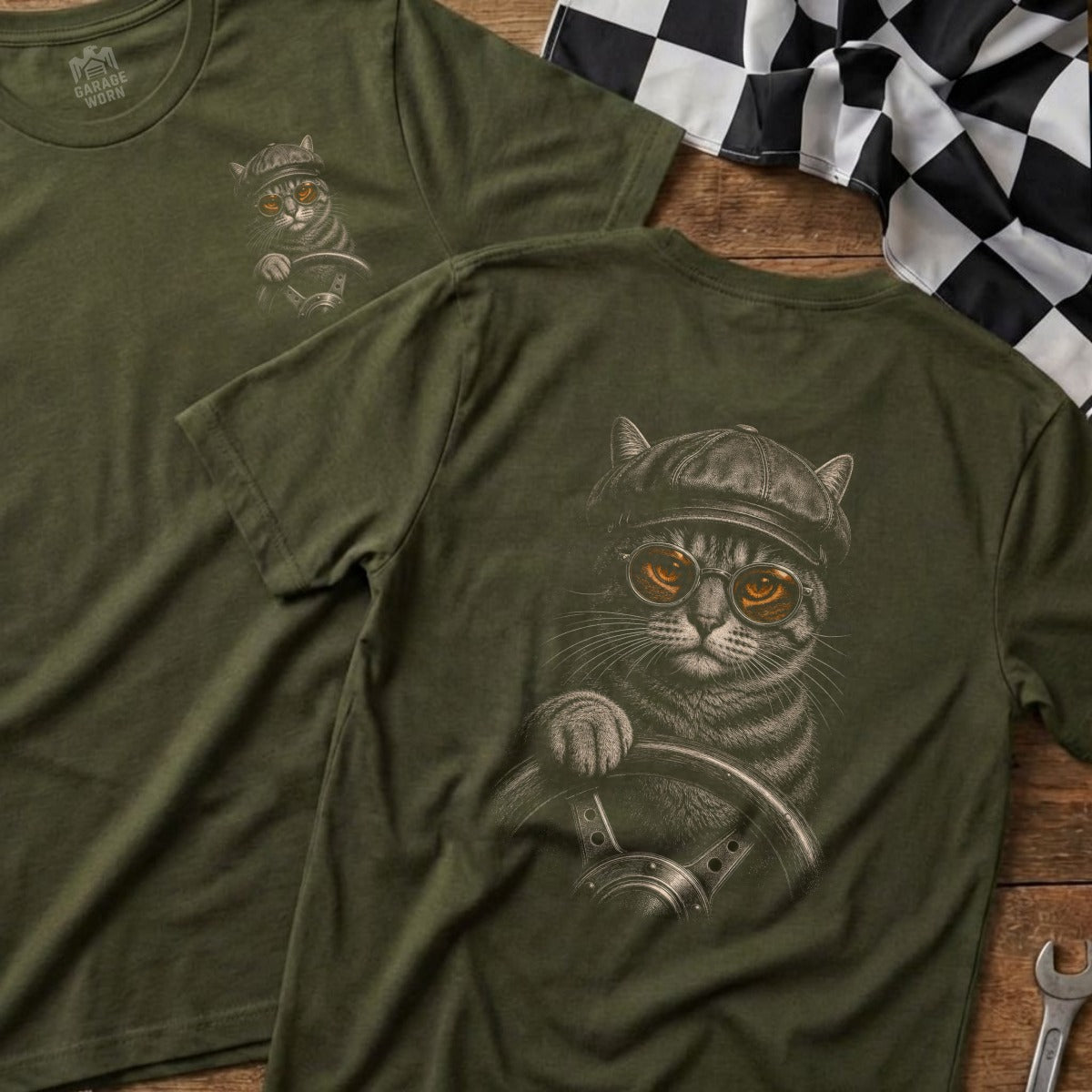 T-shirt with a cat wearing a hat and goggles driving a car.