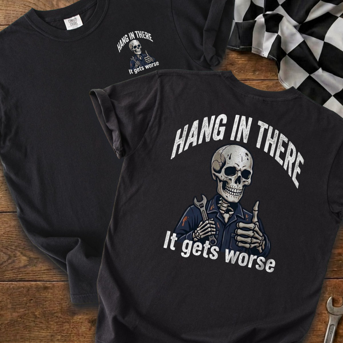 Skeleton with wrench and thumbs up, "Hang in there. It gets worse." on t-shirt.
