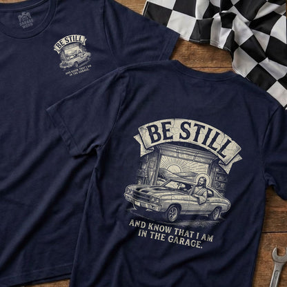 Navy t-shirt with "Be Still and Know That I Am In The Garage" and a classic car.