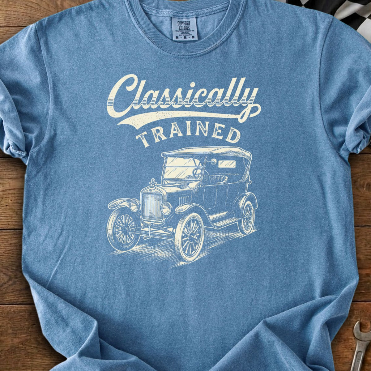 Blue t-shirt with a vintage car graphic and "Classically TRAINED" text.
