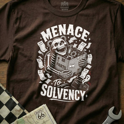 Brown t-shirt with skeleton bear holding "PARTS" box, surrounded by receipts, "MENACE To SOLVENCY".
