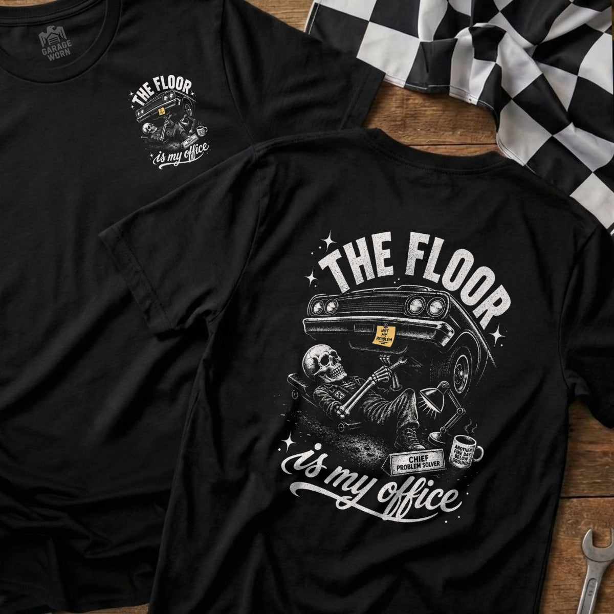 Black t-shirt with skeletal mechanic under car and text "The Floor is My Office".
