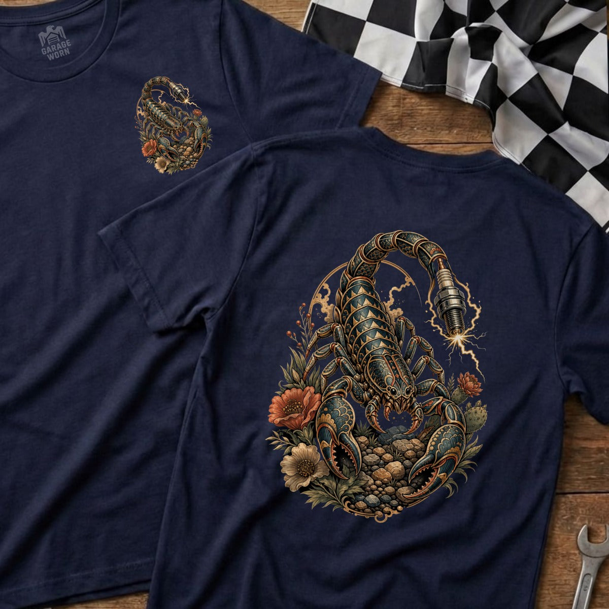 Navy t-shirt with a detailed scorpion and spark plug graphic surrounded by flowers.