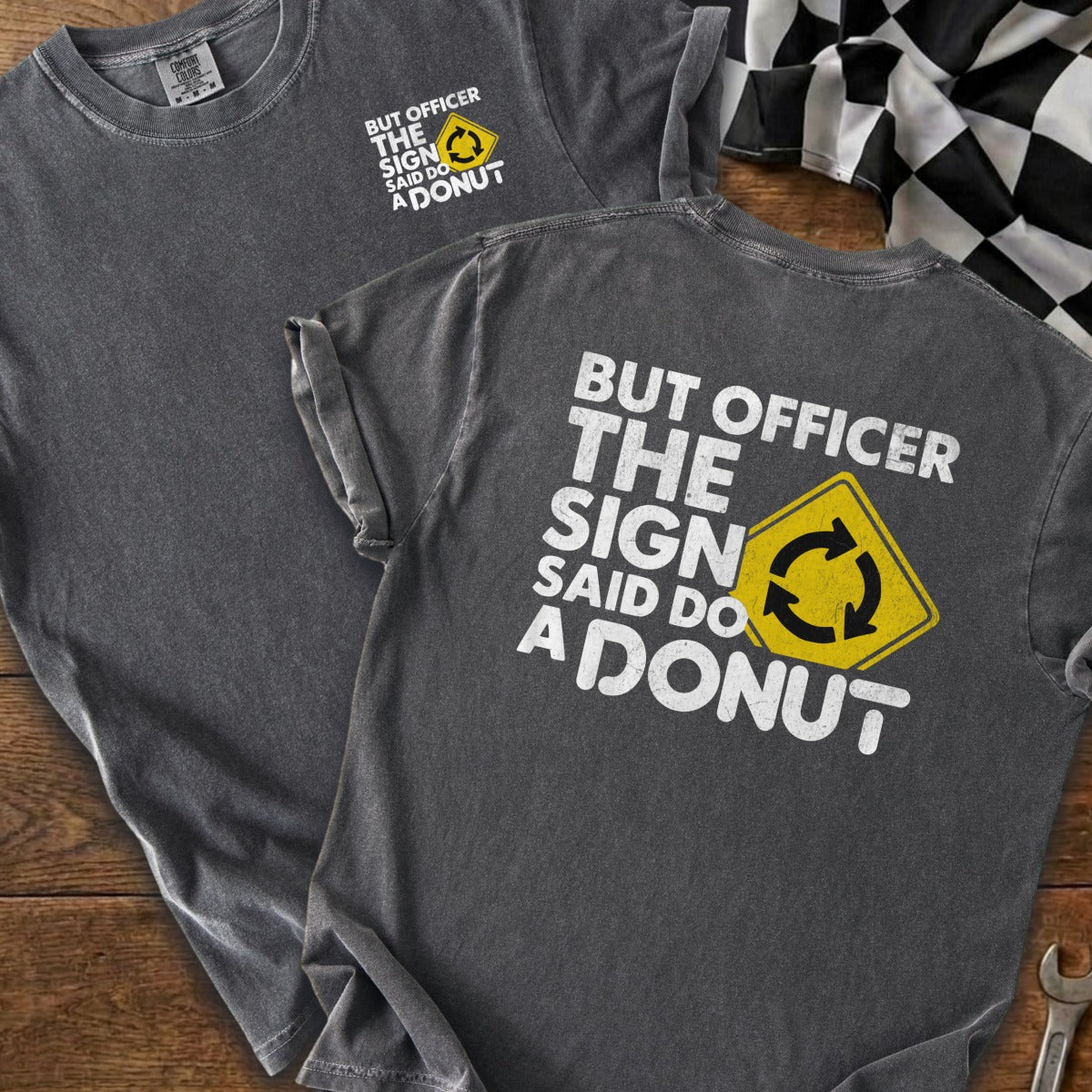 Dark gray t-shirt with "But officer the sign said do a donut" text and roundabout symbol.