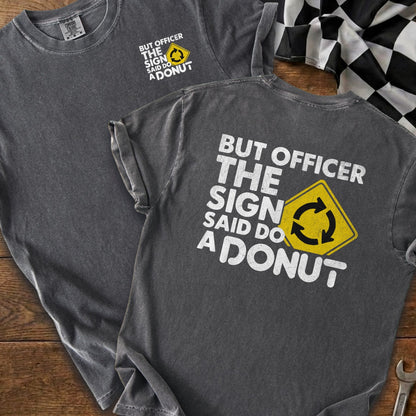 Dark gray t-shirt with "But officer the sign said do a donut" text and roundabout symbol.