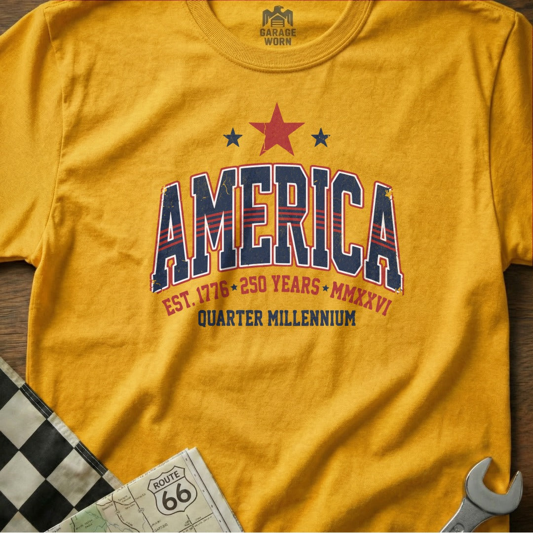 Yellow t-shirt with "AMERICA QUARTER MILLENNIUM" graphic.