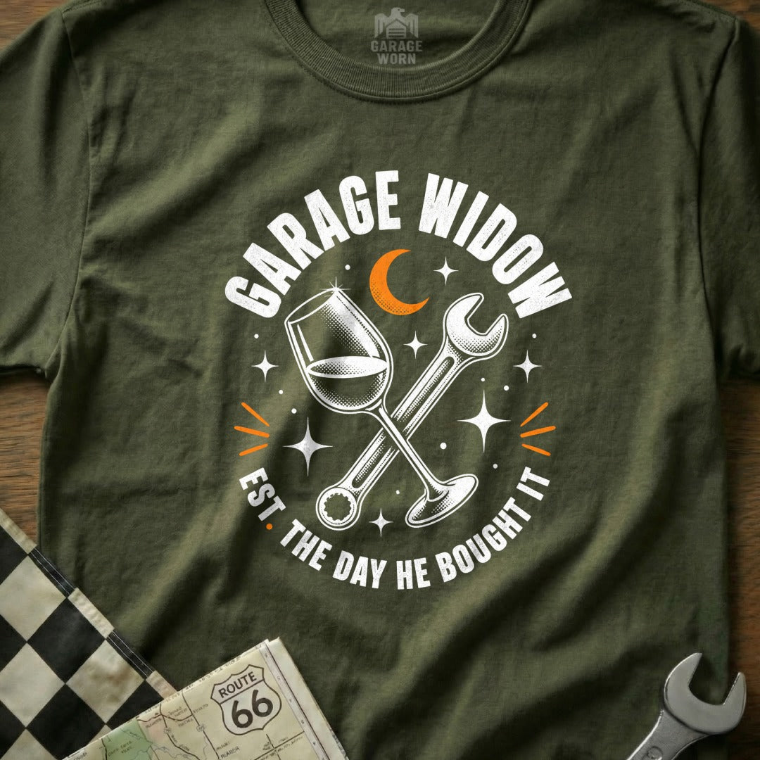 Green t-shirt with "Garage Widow Est. The Day He Bought It" text, wine glass, and wrench.