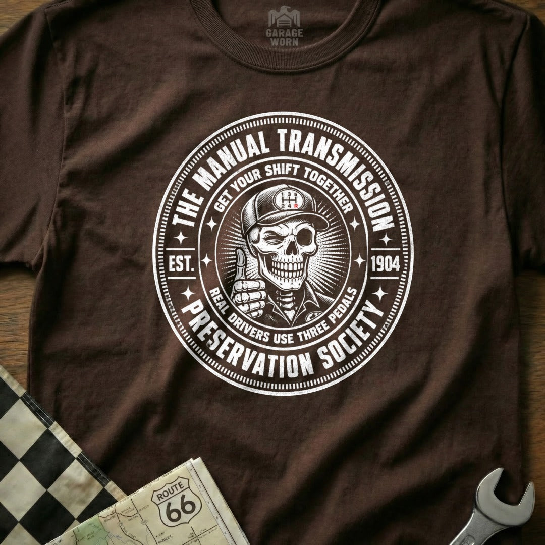 Brown t-shirt with "Manual Transmission Preservation Society" and a skull graphic.