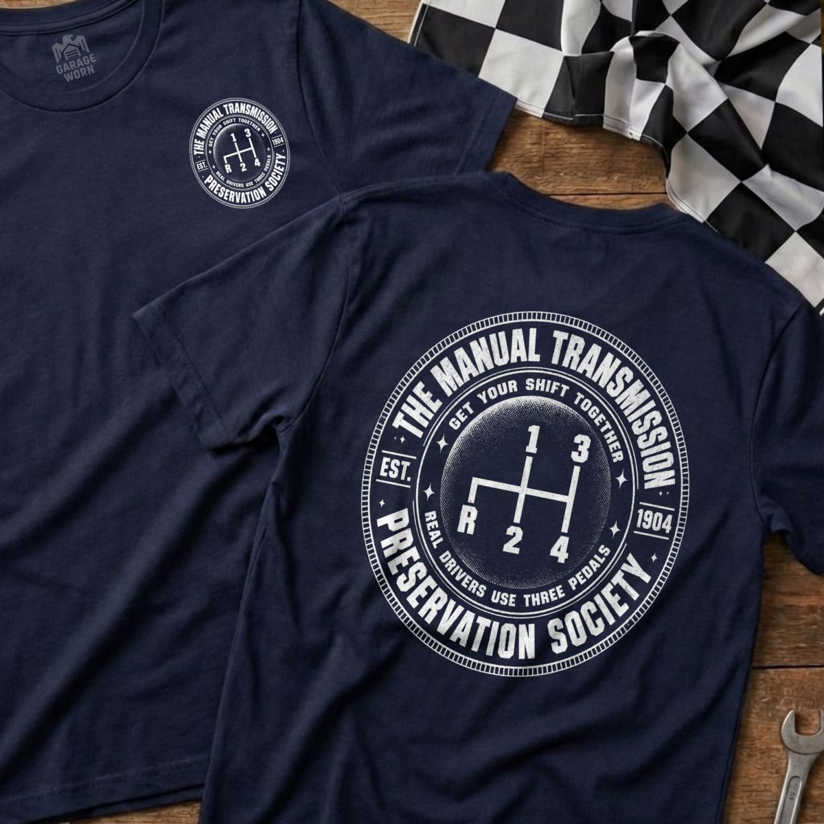 Navy t-shirt with "The Manual Transmission Preservation Society" graphic and gear shifter.