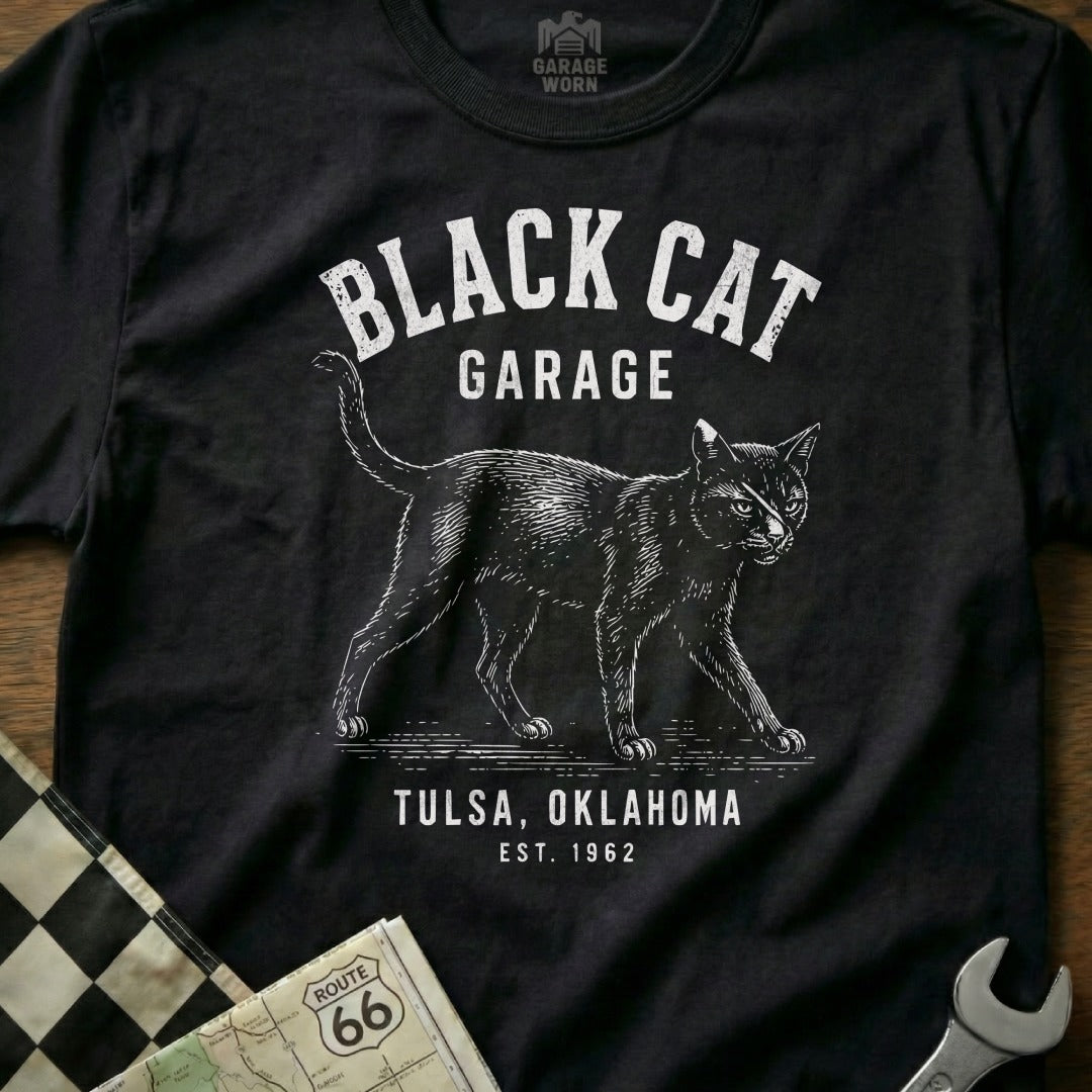 Black cat graphic t-shirt with "Black Cat Garage Tulsa, Oklahoma Est. 1962" text.