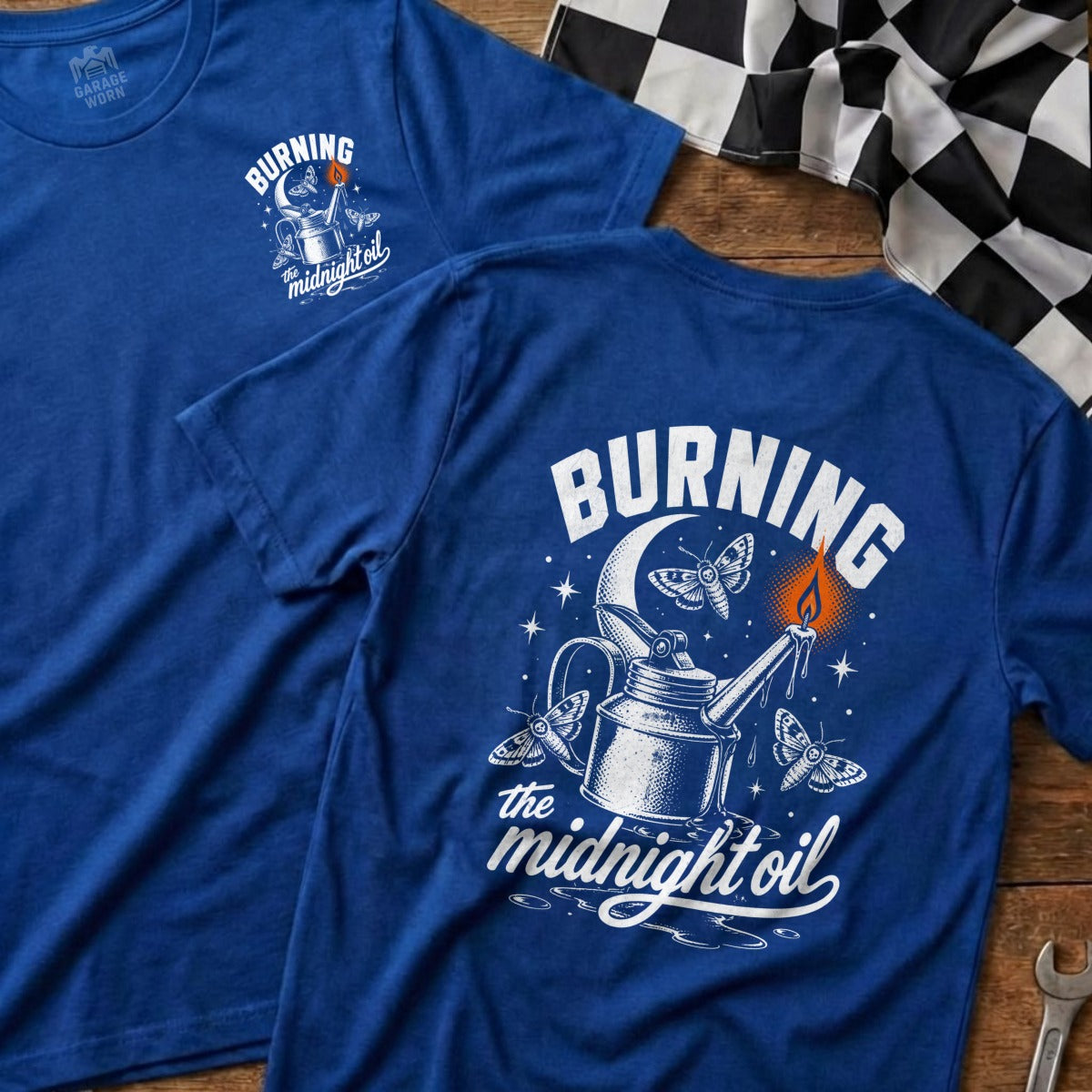 Blue t-shirt with "BURNING the midnight oil" graphic of moths around a candle.