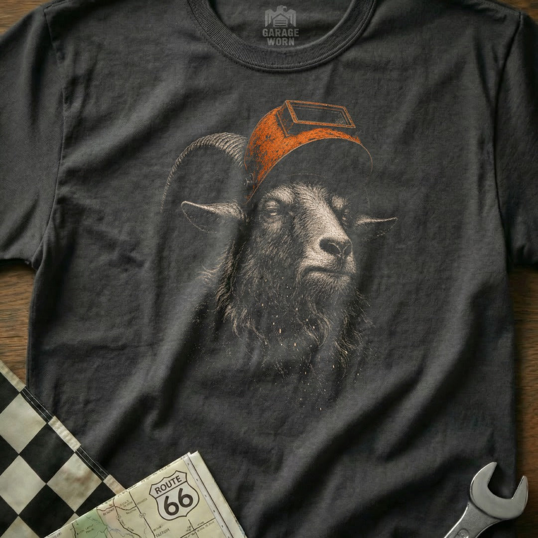 Dark t-shirt with a graphic of a goat wearing a welding mask, near Route 66 map.