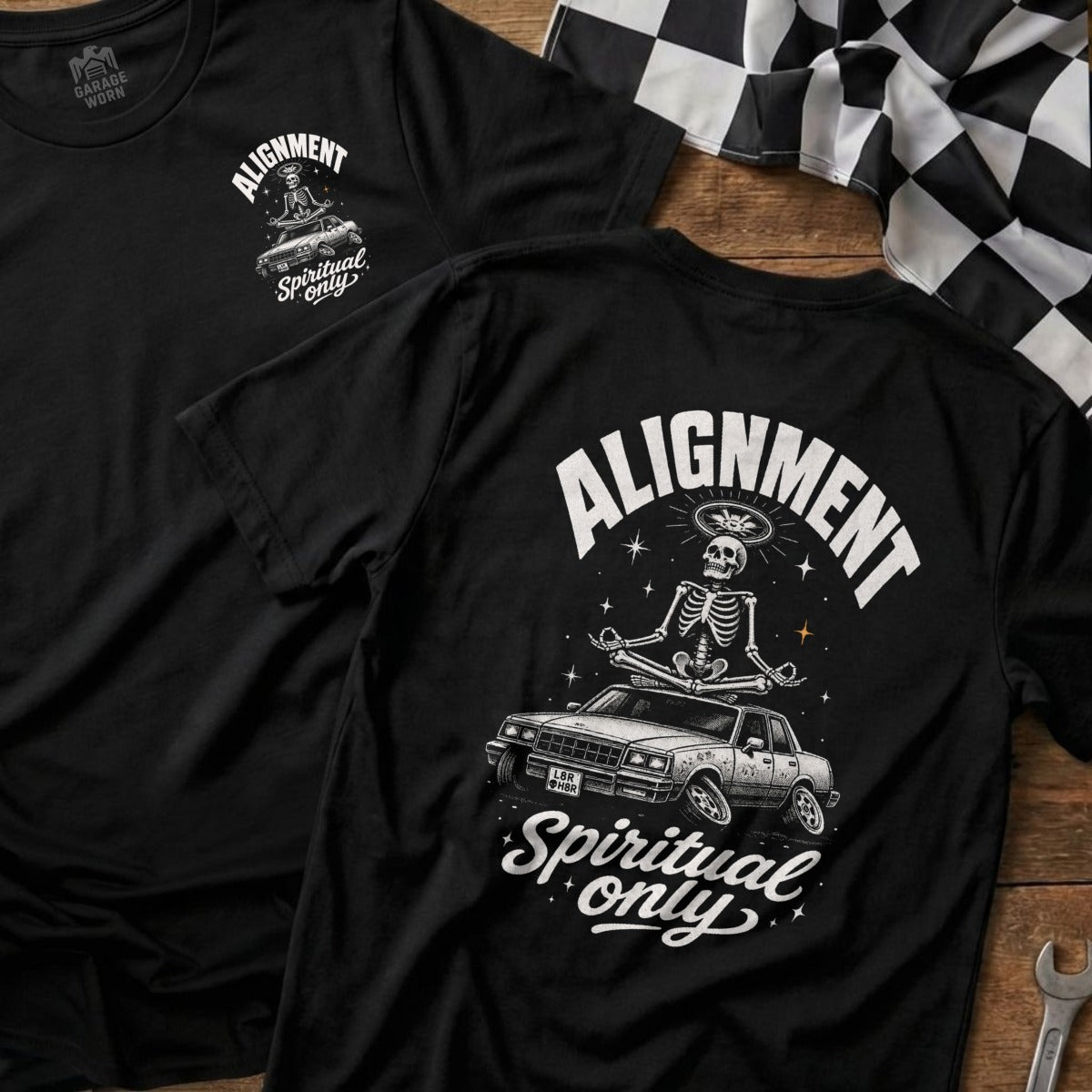 Black t-shirt with skeleton meditating on car, text "Alignment Spiritual only".