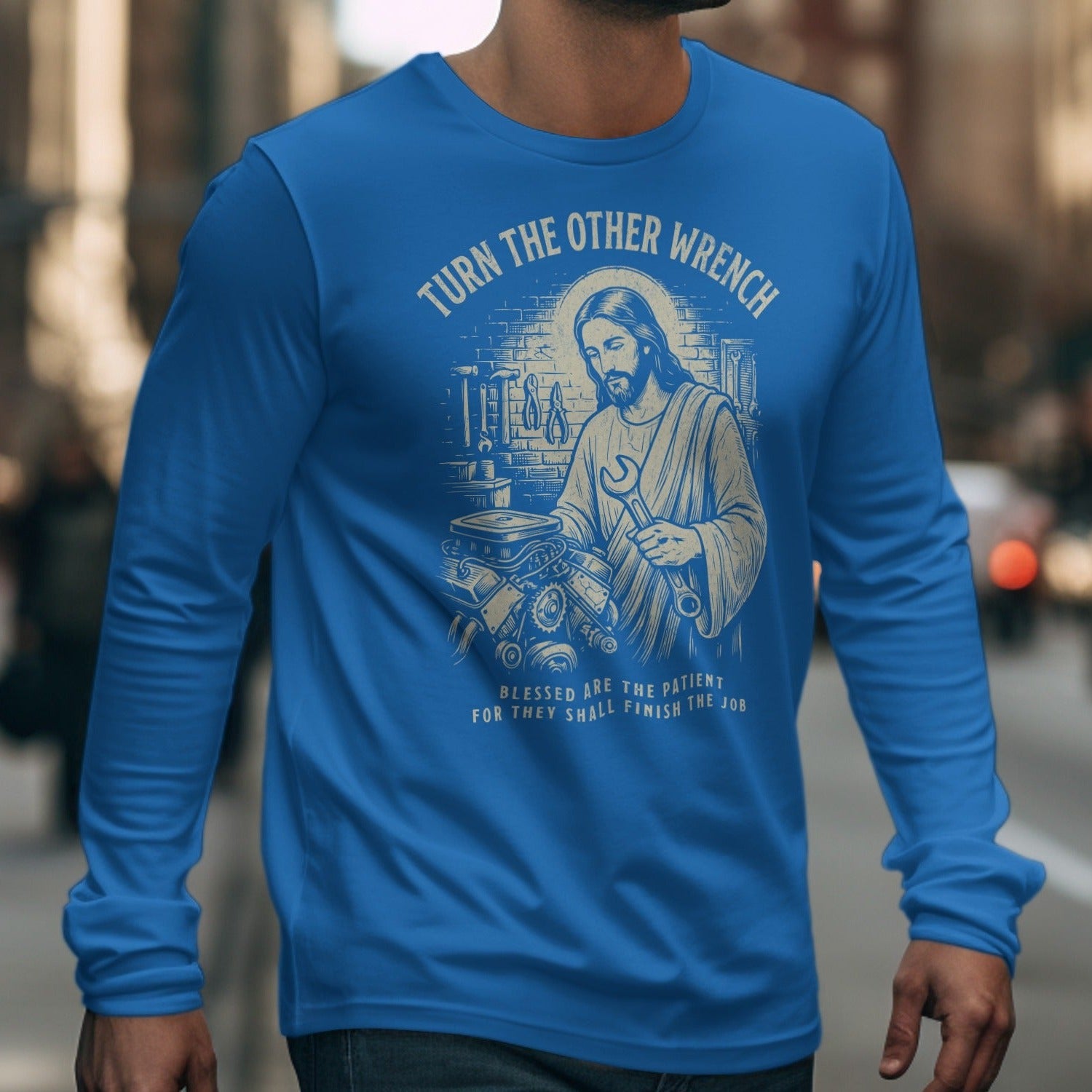 Jesus holding a wrench in a garage with text "TURN THE OTHER WRENCH".
