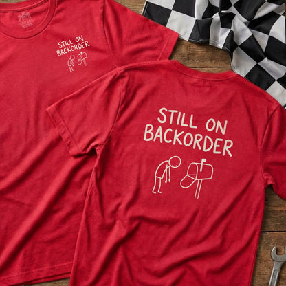 Red t-shirt with "Still on Backorder" text and a stick figure mailman.