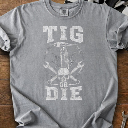 Grey t-shirt with distressed "TIG OR DIE" graphic and welding equipment.