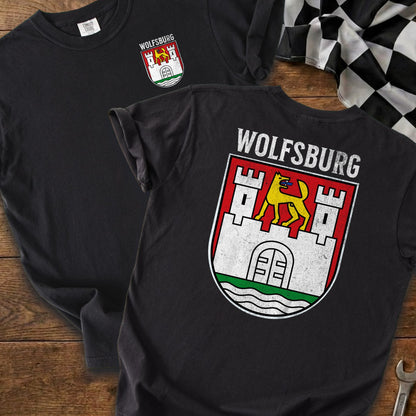 Black t-shirt with Wolfsburg crest featuring a wolf and castle, and checkered flag.