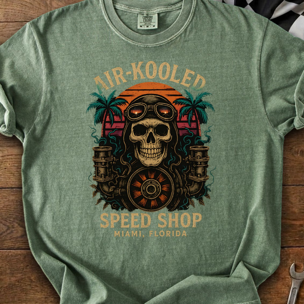 Skull with goggles and engine parts above "Air-Kooled Speed Shop Miami, Florida".