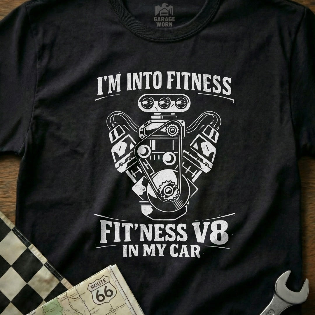 Black t-shirt with white graphic of a V8 engine and text "FIT'NESS V8 IN MY CAR".