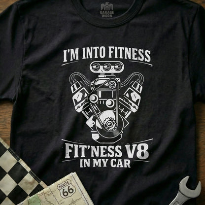 Black t-shirt with white graphic of a V8 engine and text "FIT'NESS V8 IN MY CAR".