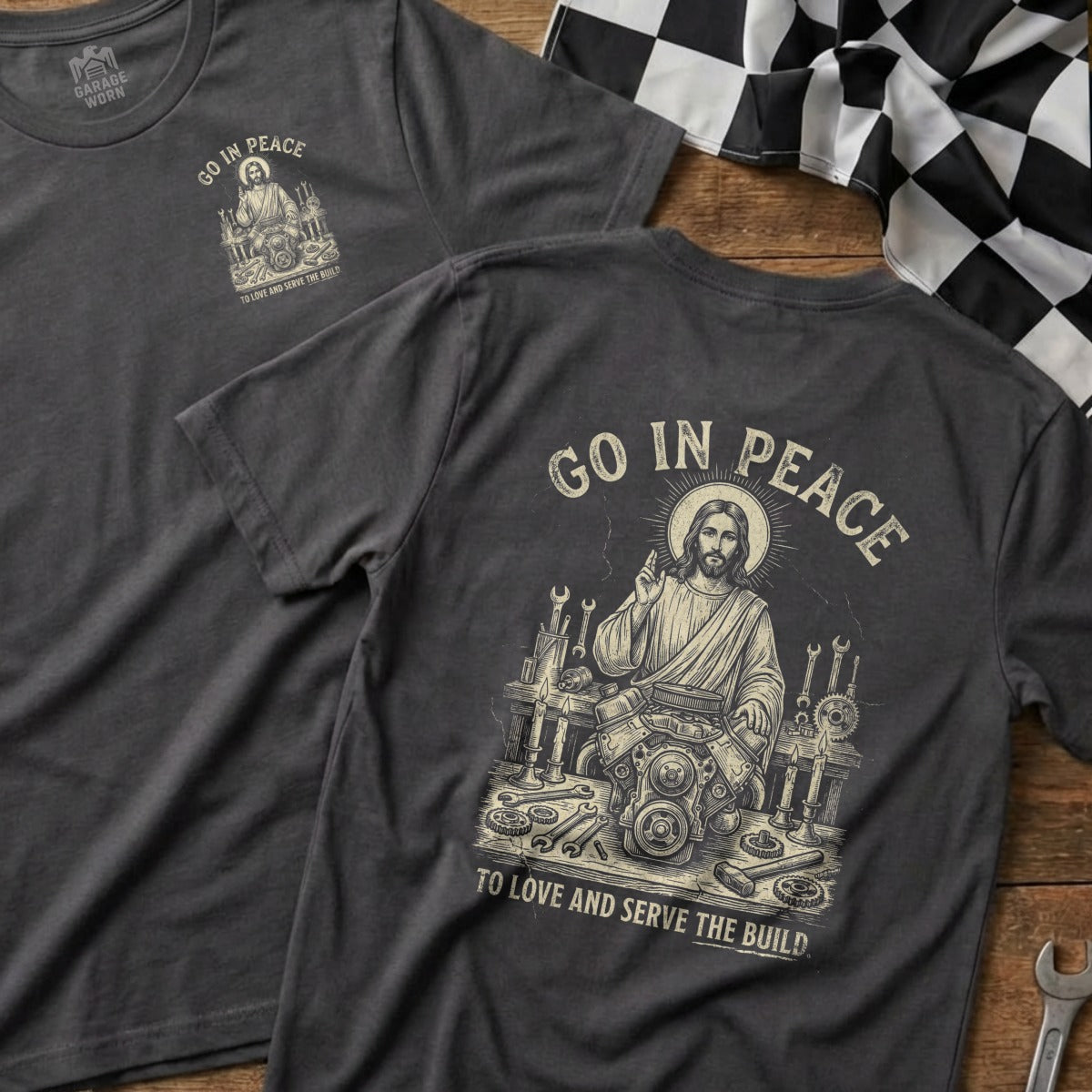 Dark t-shirt with "Go in Peace" and Jesus working on an engine.