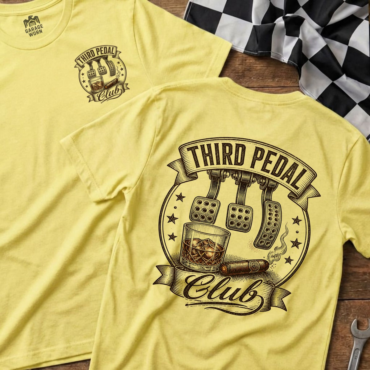 Yellow t-shirt with "Third Pedal Club" logo featuring car pedals, whiskey, and cigar.