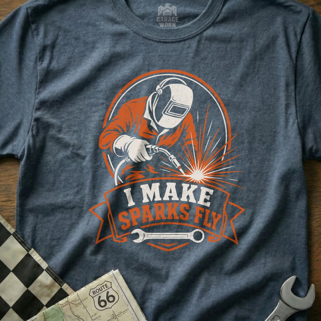 Welder wearing helmet and protective gear, sparks flying, text "I MAKE SPARKS FLY."