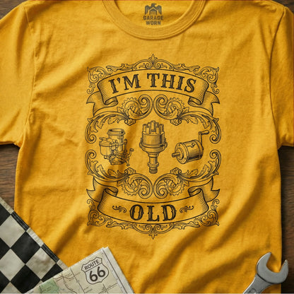 Yellow t-shirt with "I'm This Old" text and vintage automotive engine parts.