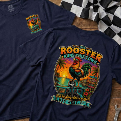Navy t-shirt with graphic of rooster, beach sunset, and gear shift with text "The Rooster Runs This Town".