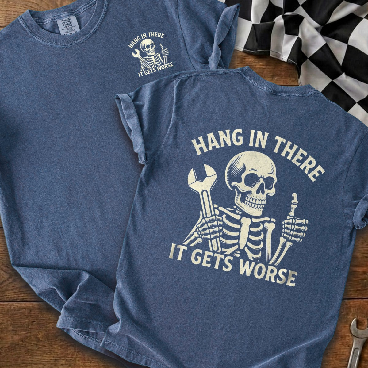 Blue t-shirt with skeleton graphic and text "HANG IN THERE IT GETS WORSE."