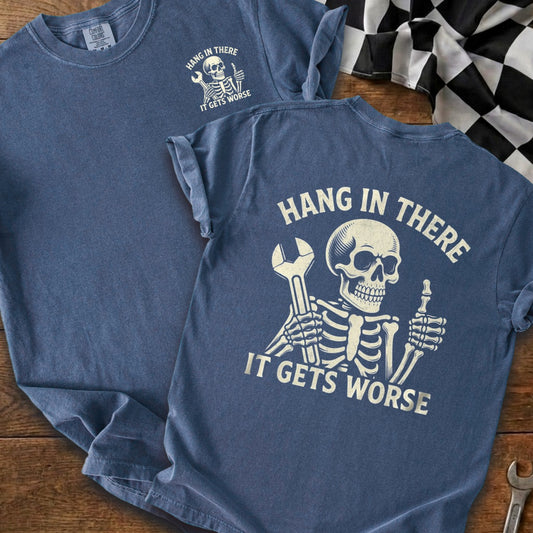 Blue t-shirt with skeleton graphic and text "HANG IN THERE IT GETS WORSE."