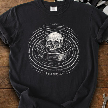 Black t-shirt featuring a skull in an oil drain with "3,000 MILES AGO" text.