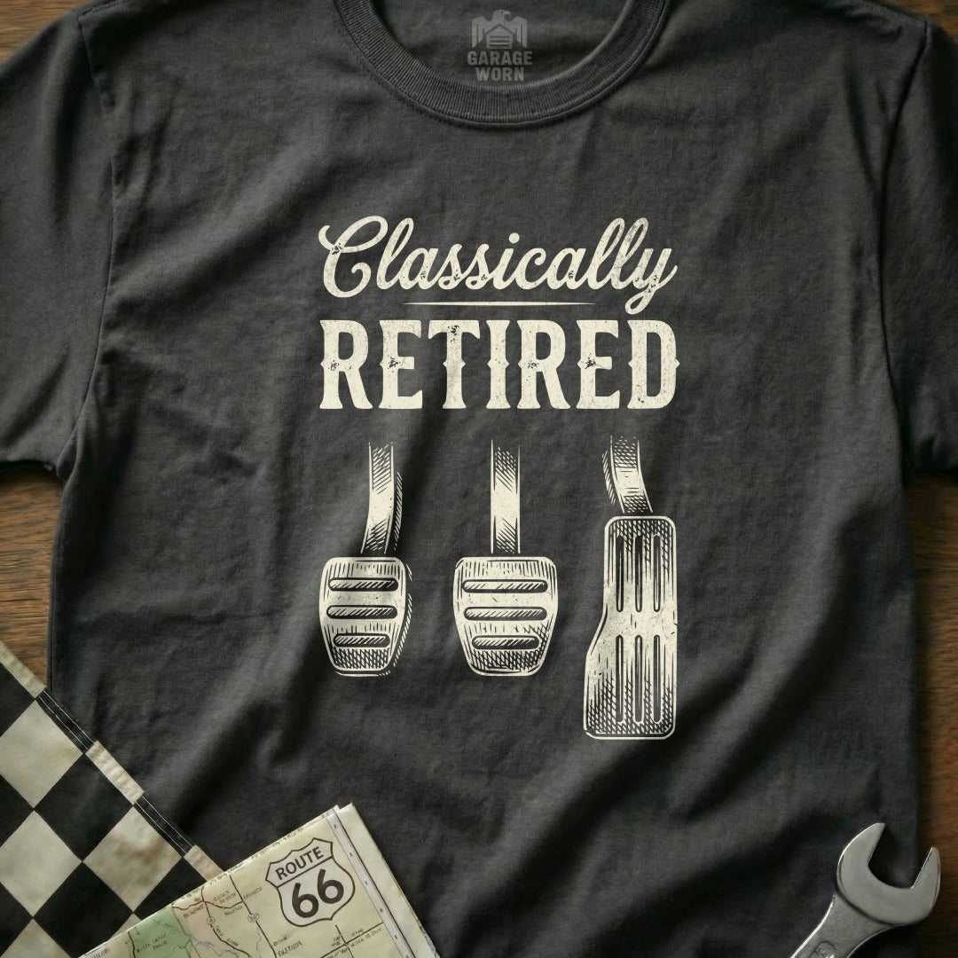 Dark t-shirt with "Classically RETIRED" text and car pedals.