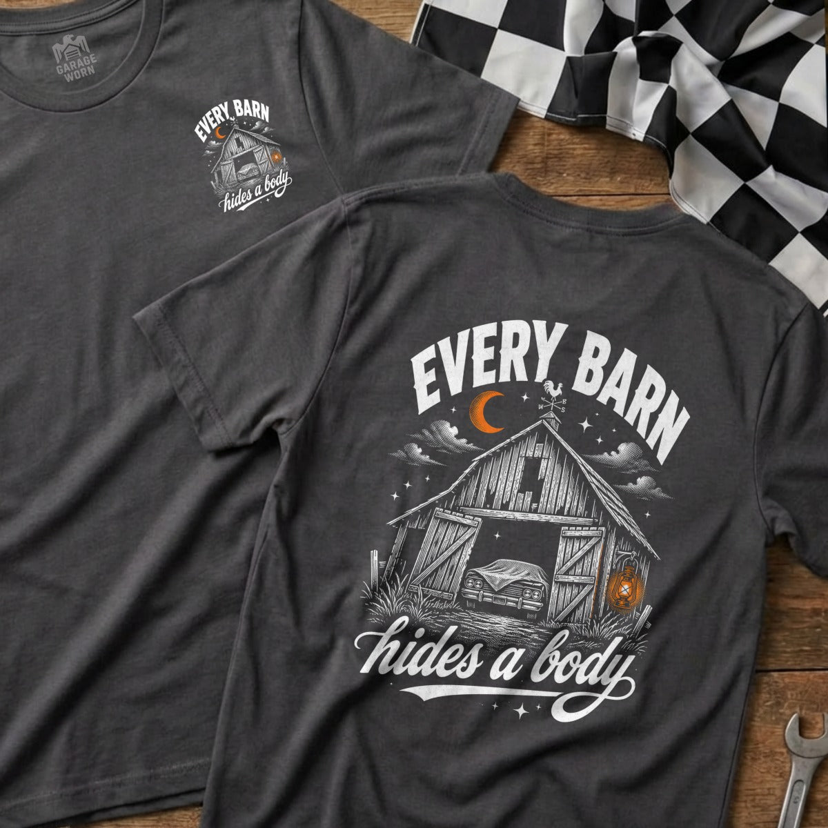 Dark t-shirt with "Every Barn Hides A Body" graphic featuring a barn with a covered car.
