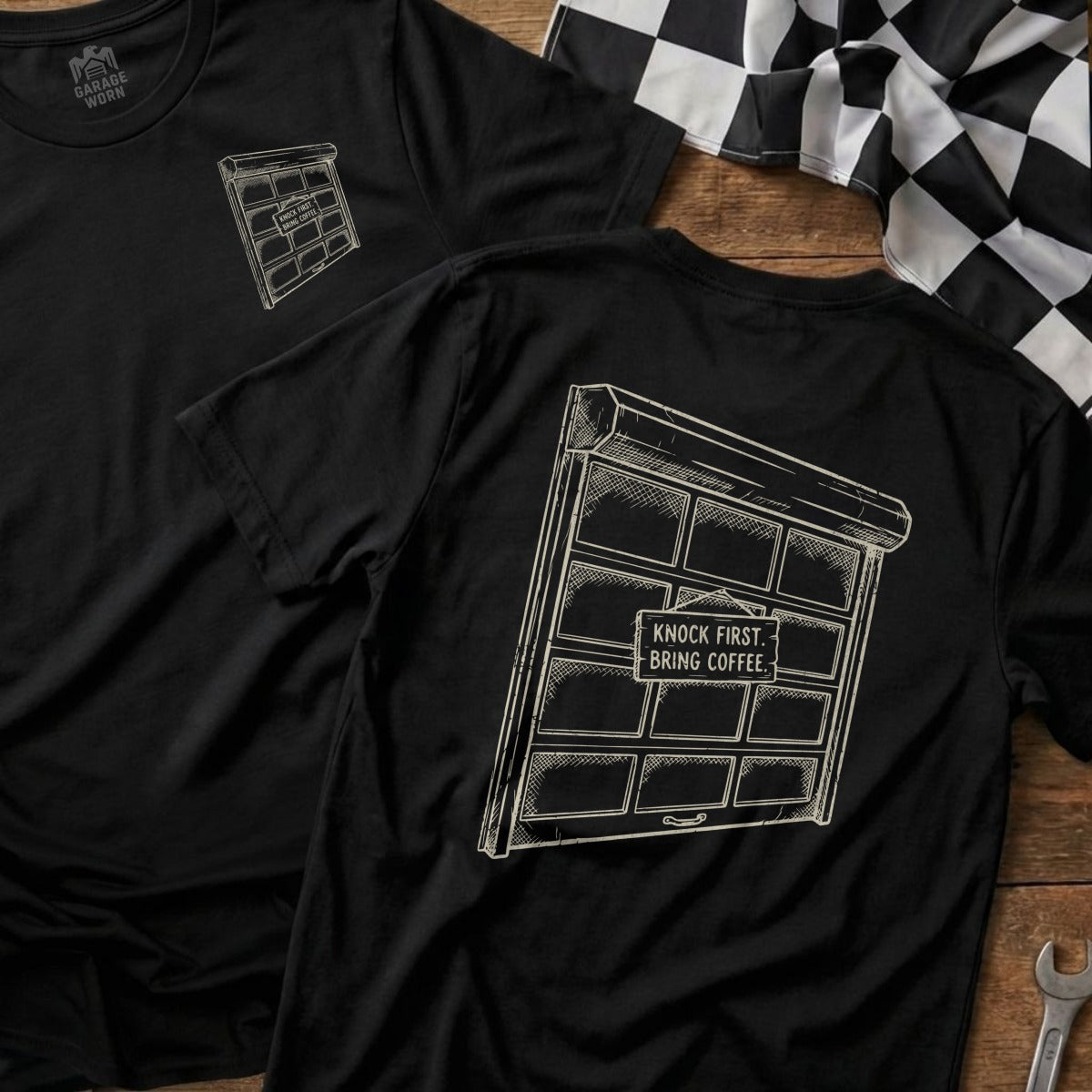 Black t-shirt with a drawing of a garage door and text "Knock first, bring coffee."