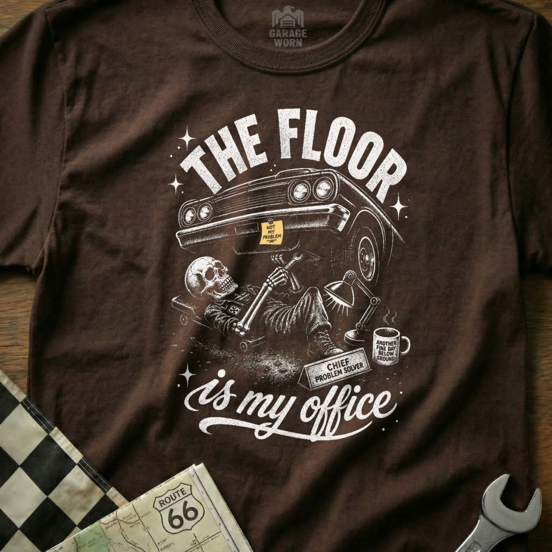 Brown t-shirt with "The floor is my office" graphic featuring a skeleton mechanic under a car.