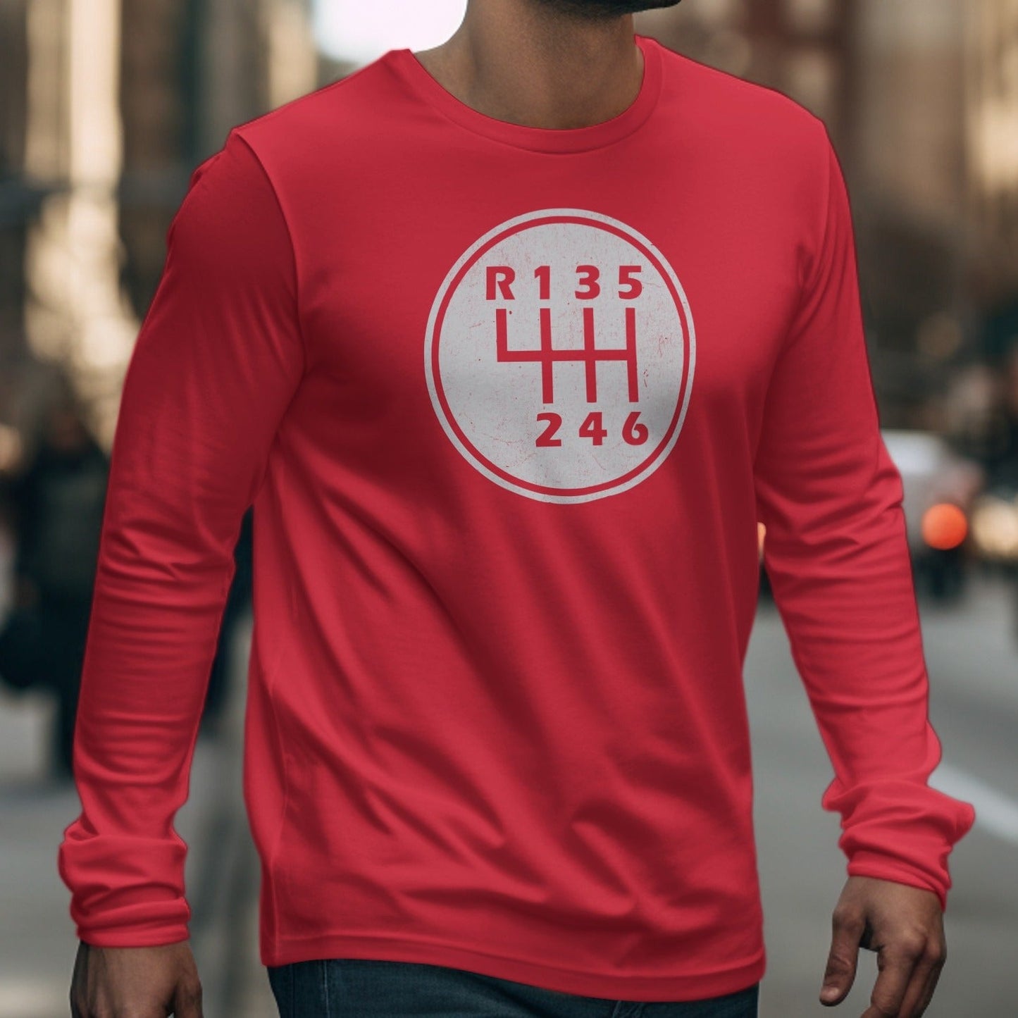 Red long sleeve shirt with white manual transmission shifter pattern on chest.