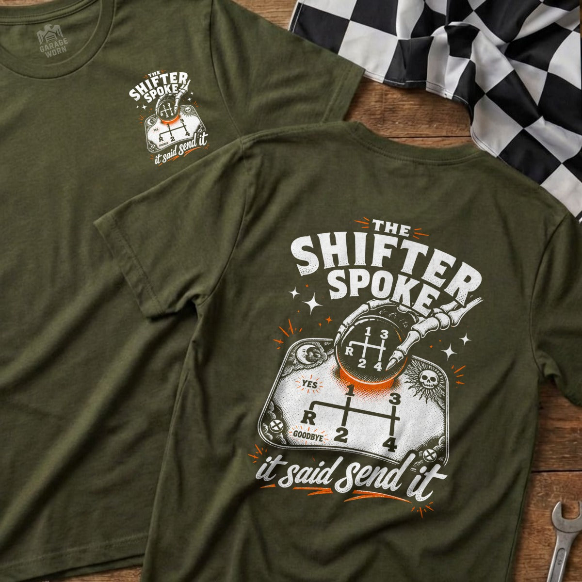 Olive green t-shirt with graphic of skeleton hand on manual shifter, "The Shifter Spoke" text.